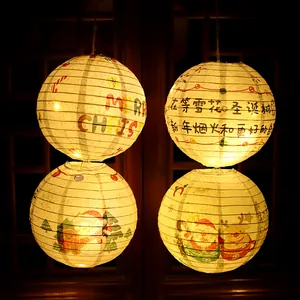 Set of 4 Christmas paper lanterns with warm internal LED lights and festive illustrations