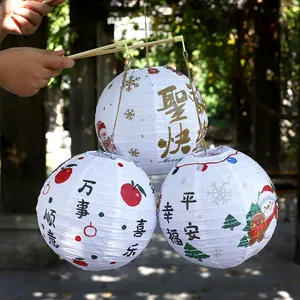 Set of three Christmas paper lanterns with snowman and cartoon prints for party decor.