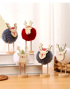 Macro view of creative Christmas reindeer ornaments featuring wooden bases and wool balls