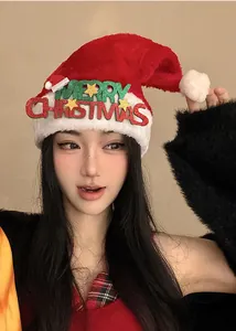 Plush red Santa hat featuring sparkling glitter Merry Christmas text decoration detail