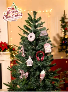 Assorted glittery Christmas tree ornaments with donut and unicorn shapes in pink