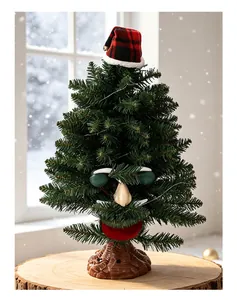 Detail view of an animated electric Christmas tree with a funny face and plaid hat
