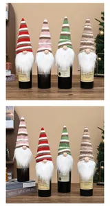 Close-up view of four knitted gnome wine bottle covers for Christmas table decoration