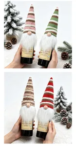 Detailed view of striped knitted gnome wine bottle covers in pink, green, and red.