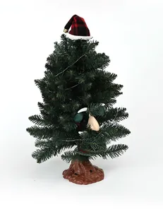 Electric singing and glowing artificial pine Christmas tree with monster face and Santa hat