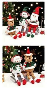 Macro view of long-legged Santa, Snowman and Reindeer plush dolls on books