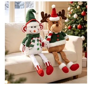 Detailed view of plush snowman and reindeer dolls sitting on a cozy holiday sofa.