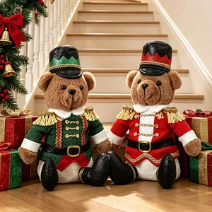Adorables peluches de oso de peluche soldado cascanueces de Navidad sentados de gala.