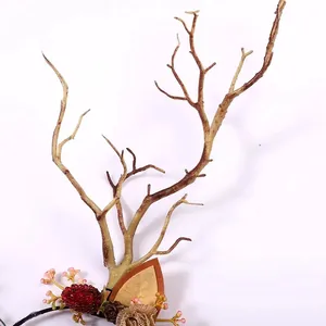 Detailed macro view of artificial deer antlers, berries, and cones on a festive headband