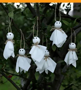 Handmade hanging white fabric ghosts for spooky Halloween party decorations on trees