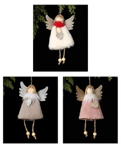 Detailed view of three plush angel girl Christmas tree ornaments in white, grey, and pink.