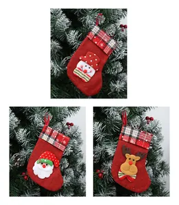 Detailed view of three festive linen Christmas stockings with Santa, Snowman, and Reindeer.
