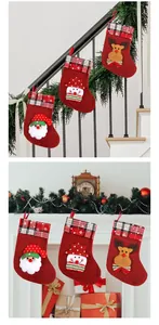 Set of three red burlap Christmas stockings hanging on a festive decorated fireplace