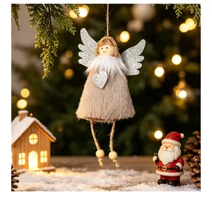 Detailed view of plush angel Christmas ornament with silver glitter wings and heart.