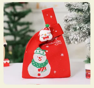 Primer plano de la bolsa de regalo de Navidad de punto roja con diseño de muñeco