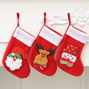 Set of three red Christmas stockings with Santa, reindeer, and snowman designs hanging