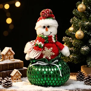 Figura de muñeco de nieve navideño en bolsa de regalo con lentejuelas verdes decorativa.