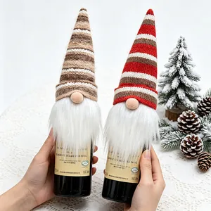 Two festive knitted Christmas gnome wine bottle covers with long beards for holiday table decor