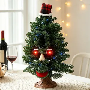 Animated electric Christmas tree with glowing red eyes and festive plaid hat table decor