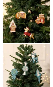 Diverse Christmas tree ornaments including gingerbread house and reindeer on green branches