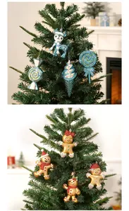 Macro detail view of blue glitter reindeer and golden gingerbread man Christmas ornaments