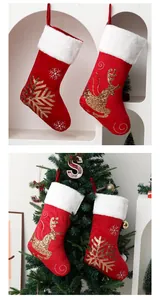 Set of festive red velvet Christmas stockings with gold sequin reindeer and snowflake patterns
