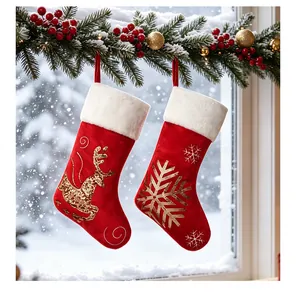 Close-up of red velvet Christmas stockings with sequined reindeer and snowflake designs