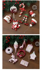 Close-up of red and pink themed festive Christmas tree ornaments on a wooden background