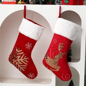 Festive red Christmas stockings with gold sequin snowflake and reindeer embroidery patterns.