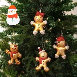 Set of four gold-plated gingerbread man Christmas tree ornaments featuring red glitter details