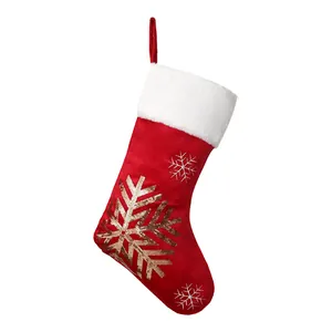 Red Christmas stocking with gold sequin snowflake decoration and white faux fur trim