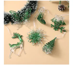 Assorted green glitter and transparent Christmas tree ornaments in various shapes
