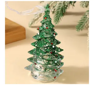 Close-up detail of a transparent green glitter Christmas tree ornament with a hanging ribbon