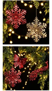 Close-up of shiny red and gold snowflake and butterfly ornaments on a Christmas tree.