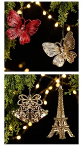 Close-up of golden and red Christmas tree ornaments with plated butterfly and bell details