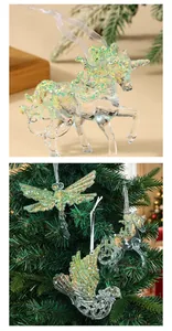 Transparent green glitter unicorn and dragonfly Christmas tree ornaments hanging on branches
