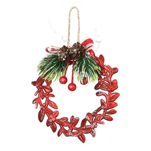 Decorative red Christmas wreath hanging ornament with pine cones and snow-tipped berries