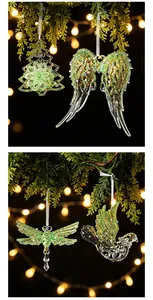 Detail view of green glitter transparent Christmas ornaments hanging on a tree