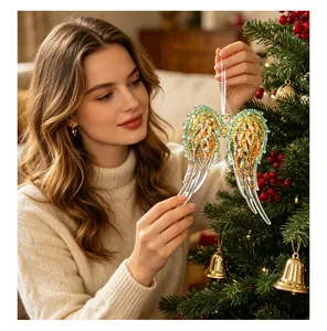 Detailed view of a woman hanging a sparkling green glitter angel wing ornament on a tree