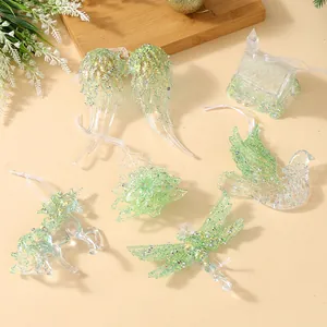 Set of sparkling green glitter transparent Christmas tree hanging ornaments in various shapes.