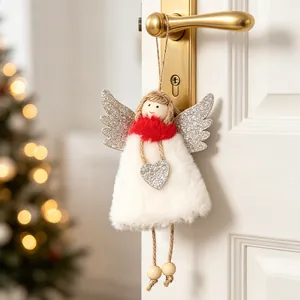 Plush angel girl Christmas ornament with glitter wings hanging on a door handle