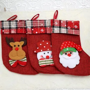 Set of three mini burlap Christmas stockings with reindeer, snowman, and Santa motifs