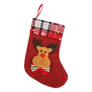 Festive red burlap Christmas stocking with a cute cartoon reindeer and plaid cuff