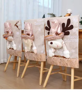 Detailed view of three festive Christmas chair covers with 3D dolls and sequins decoration.