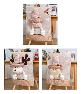 Close-up of 3D snowman, reindeer, and Santa Claus Christmas chair back covers for home decor.