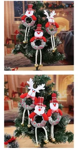 Detailed view of plush Christmas tree ornaments featuring Santa, snowman, and reindeer