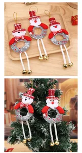 Close-up of cute plush Christmas tree ornaments featuring long legs with golden bells