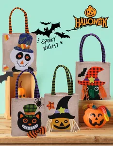 Detailed view of four different cartoon Halloween linen treat bags for kids' parties