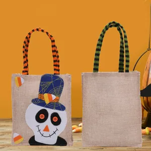 Halloween burlap candy gift bags featuring cartoon skull character and striped handles