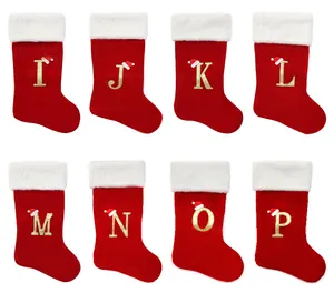 Red Christmas stockings with gold glitter letters I to P and mini Santa hats decoration
